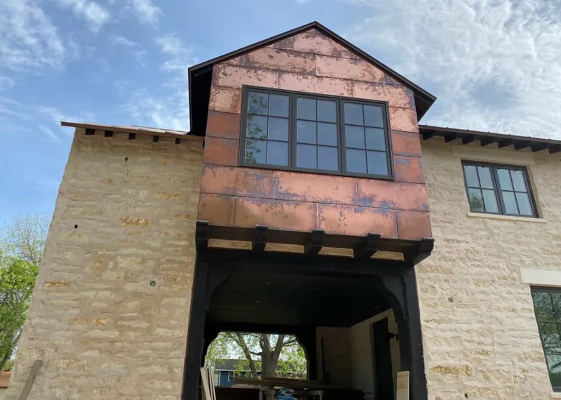 Copper metal panel facade on a stone building for Roof Repair in Colleyville