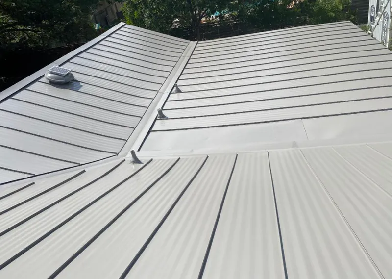 Solar attic fan installed on a metal roof for Roof Ventilation in Colleyville